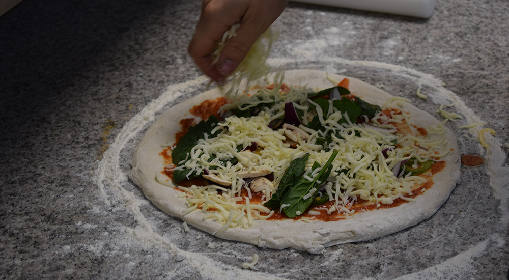 making a pizza with toppings