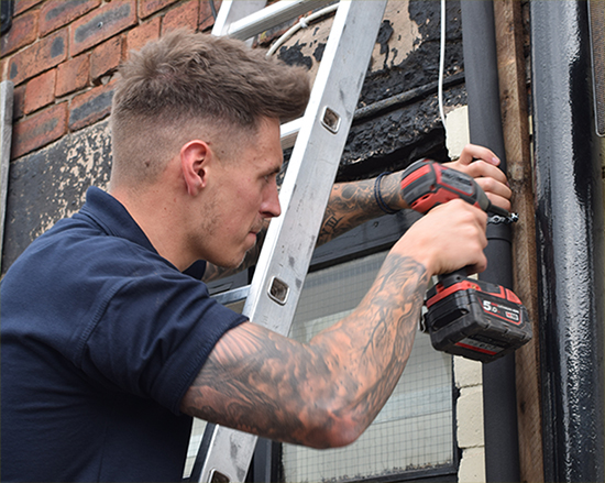 Acme Engineer up a ladder with a drill